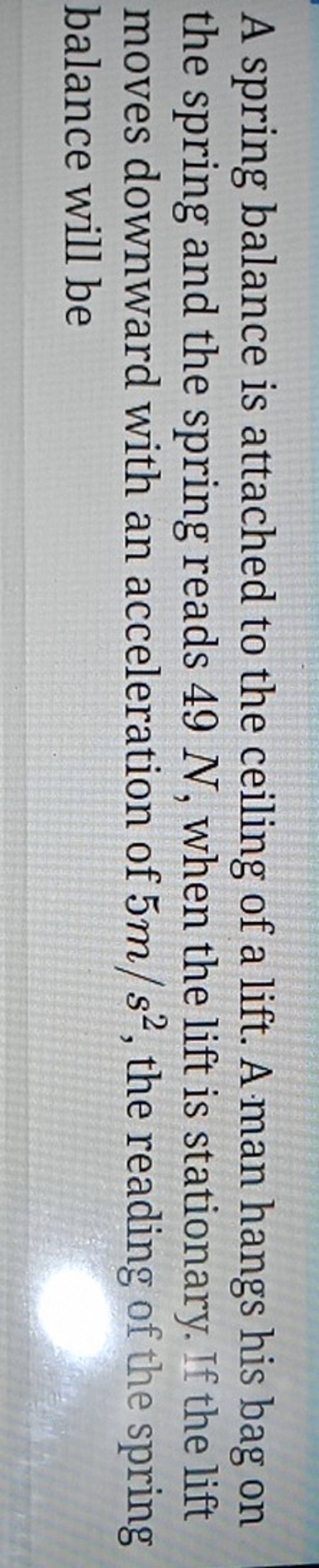 A spring balance is attached to the ceiling of a lift. A man hangs his ba..
