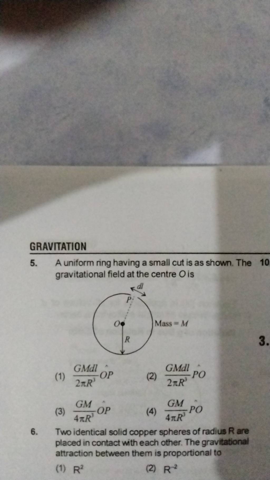 Two identical solid copper spheres of radius R are placed in contact with..