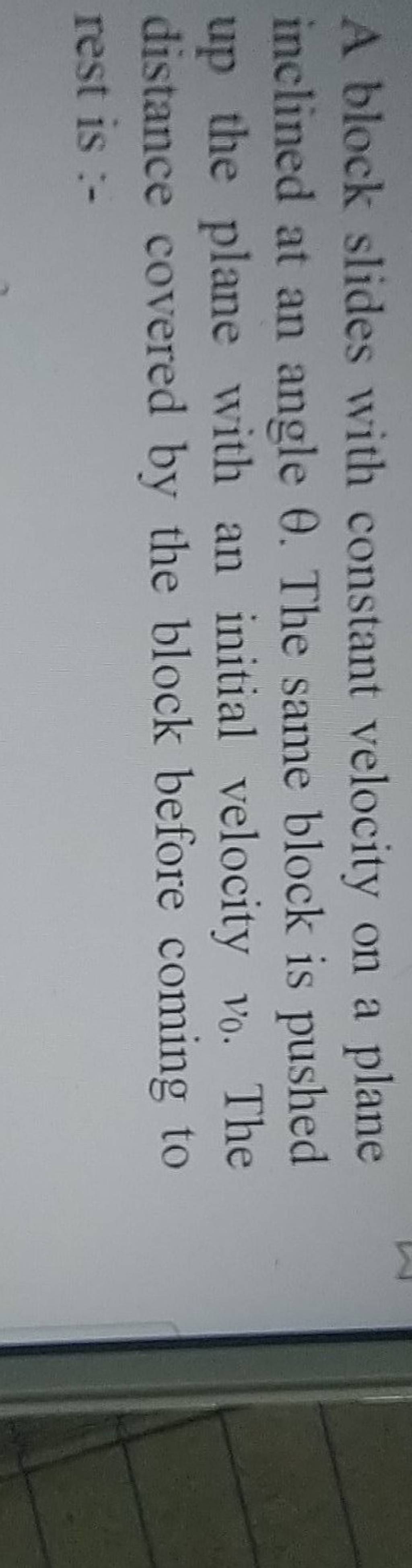 A block slides with constant velocity on a plane inclined at an angle θ.