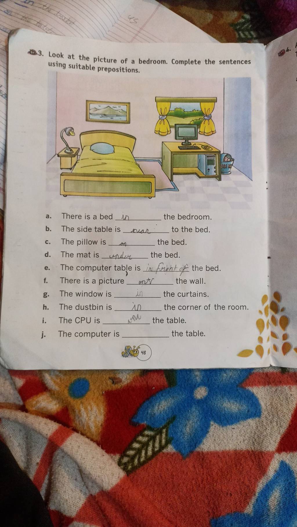 Look at the picture of a bedroom. Complete the sentences using suitable p..