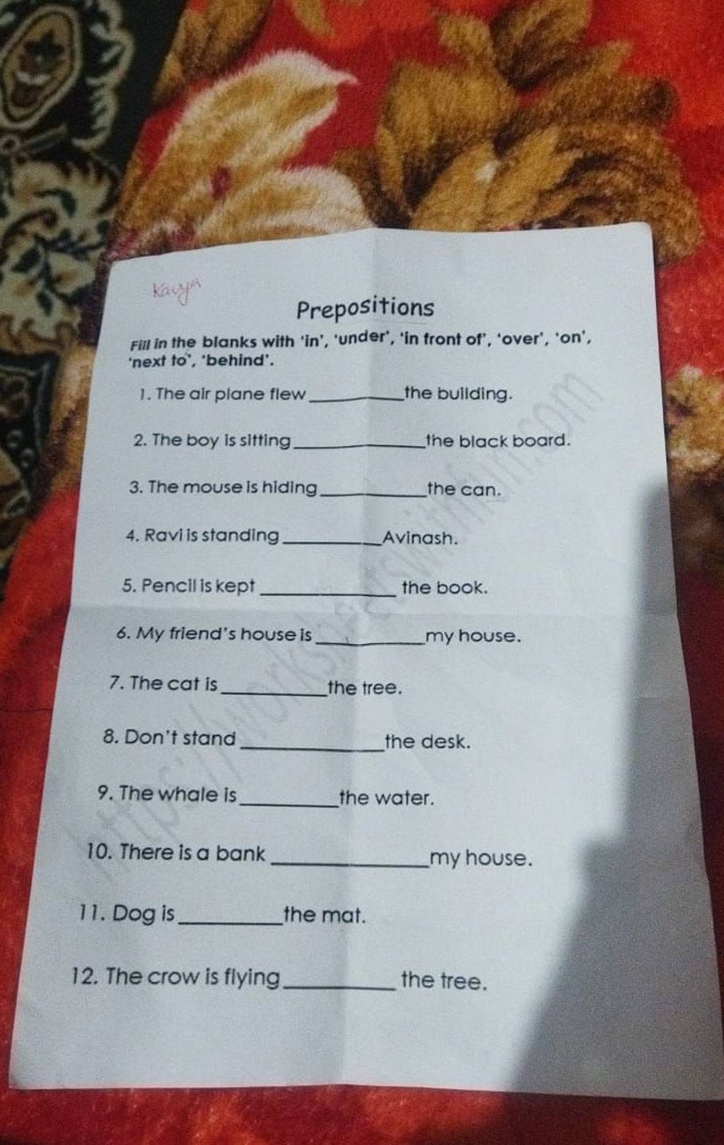 Prepositions Fill in the blanks with 'in', 'under', 'in front of', 'over'..