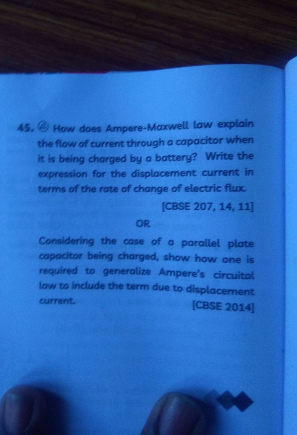 45. (a) How does Ampere-Maxwell law explain the flow of current throug