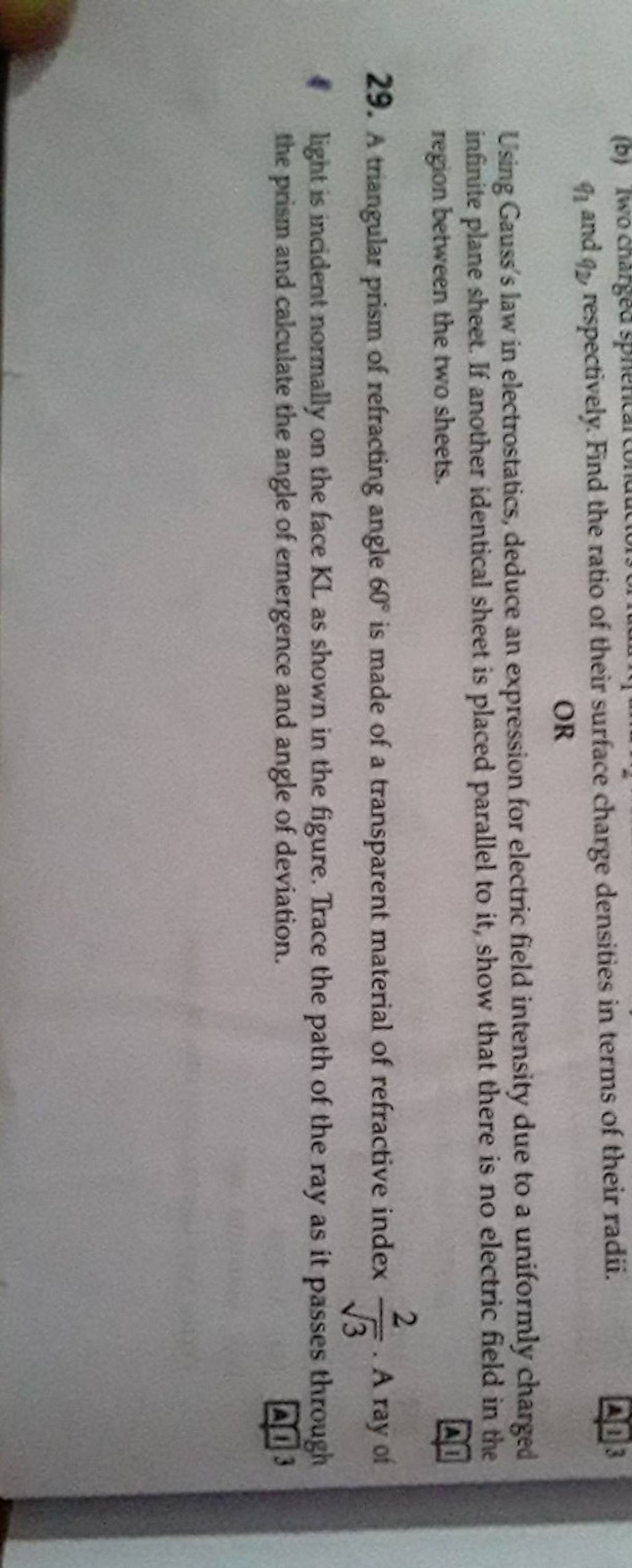 q1 and q2 respectively. Find the ratio of their surface charge densitie..